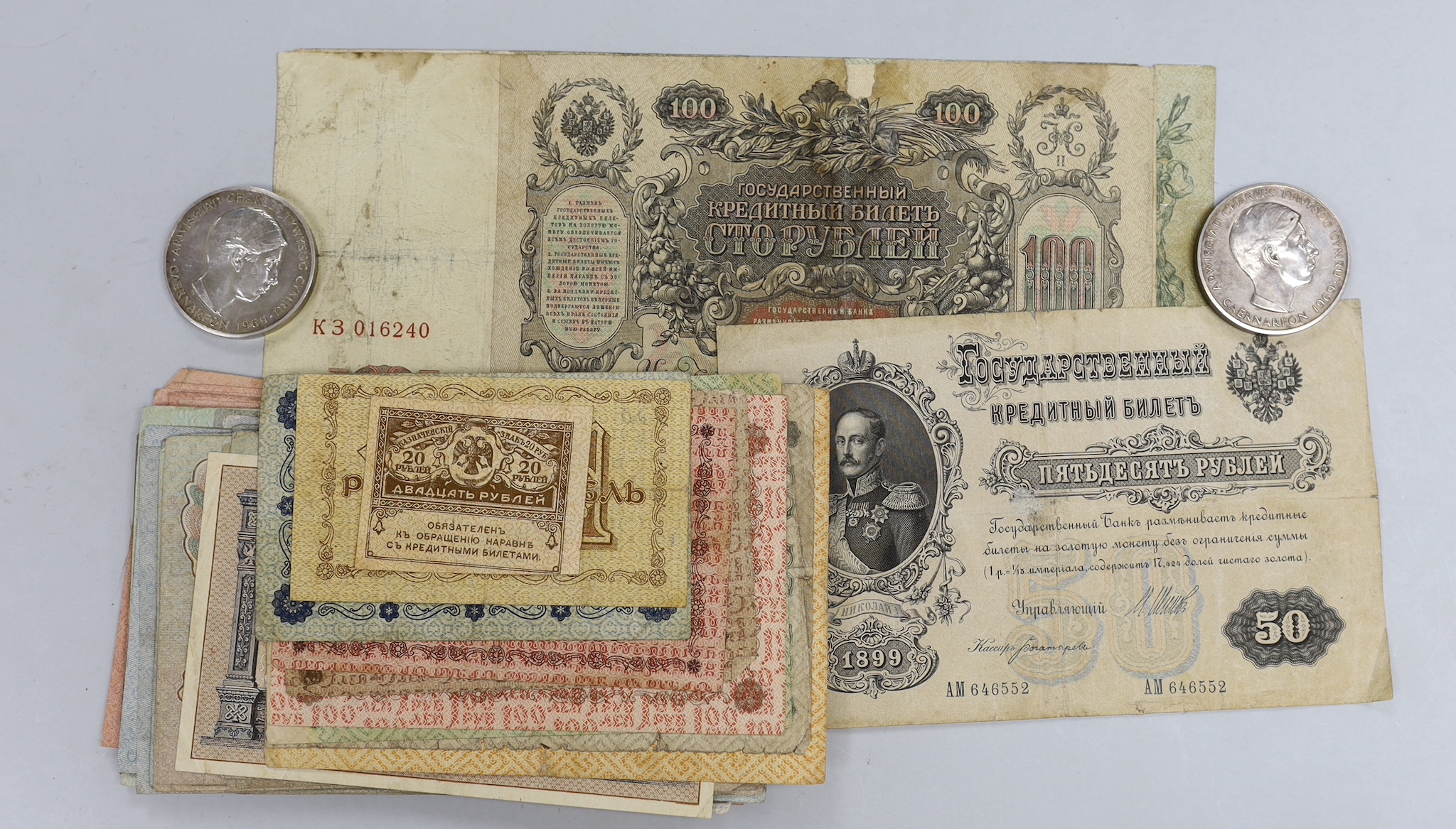 A collection of Russian pre revolutionary banknotes and two Prince Charles Prince of Wales investiture 1969 silver medals